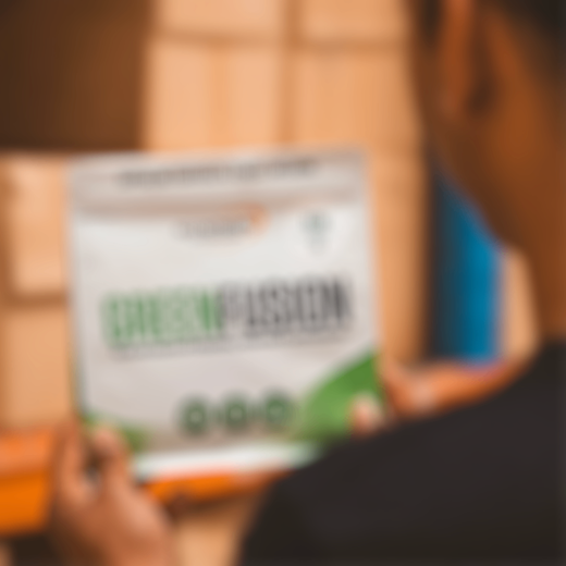 Person holding greens powder packet