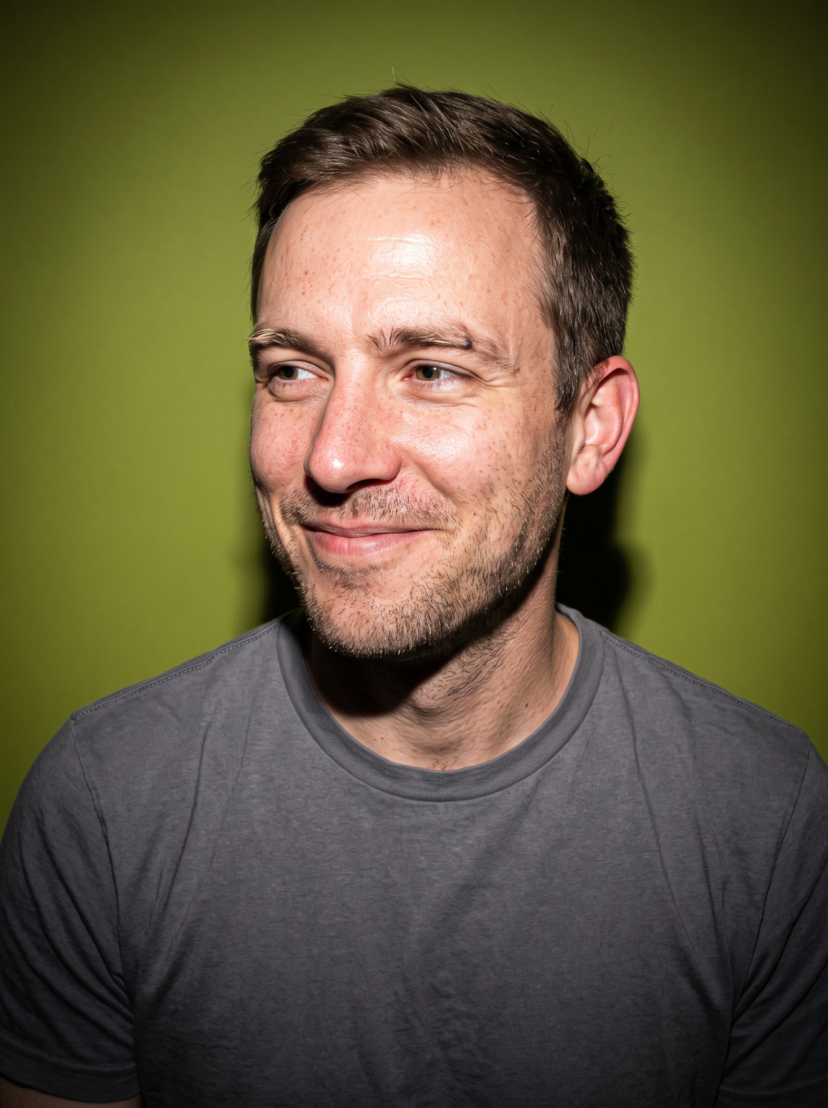 A man smiling just after eating a greens gummy