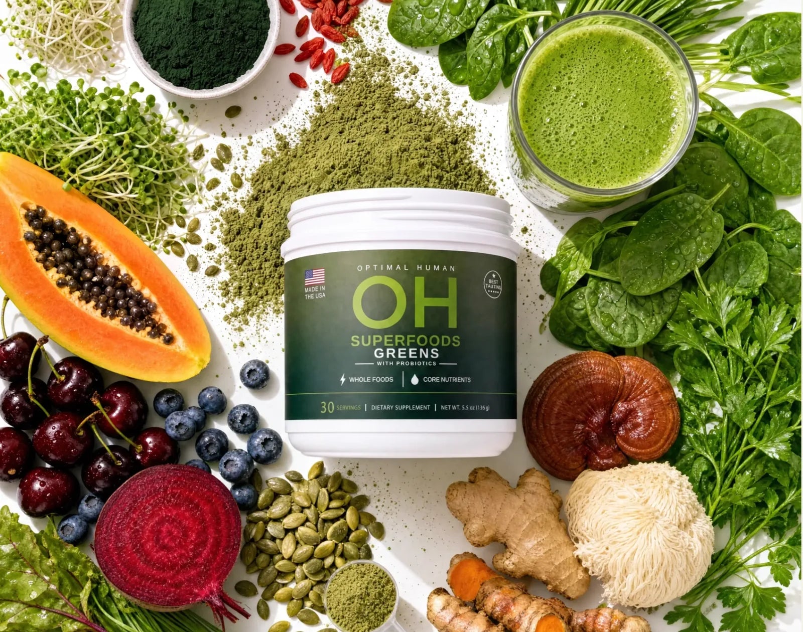 Overhead flat lay of the Superfood Greens tub surrounded by the real whole foods in it: spirulina, papaya, cherries, blueberries, beetroot, pumpkin seeds, goji, spinach, parsley, reishi, lion's mane, ginger and turmeric, with a glass of the mixed drink