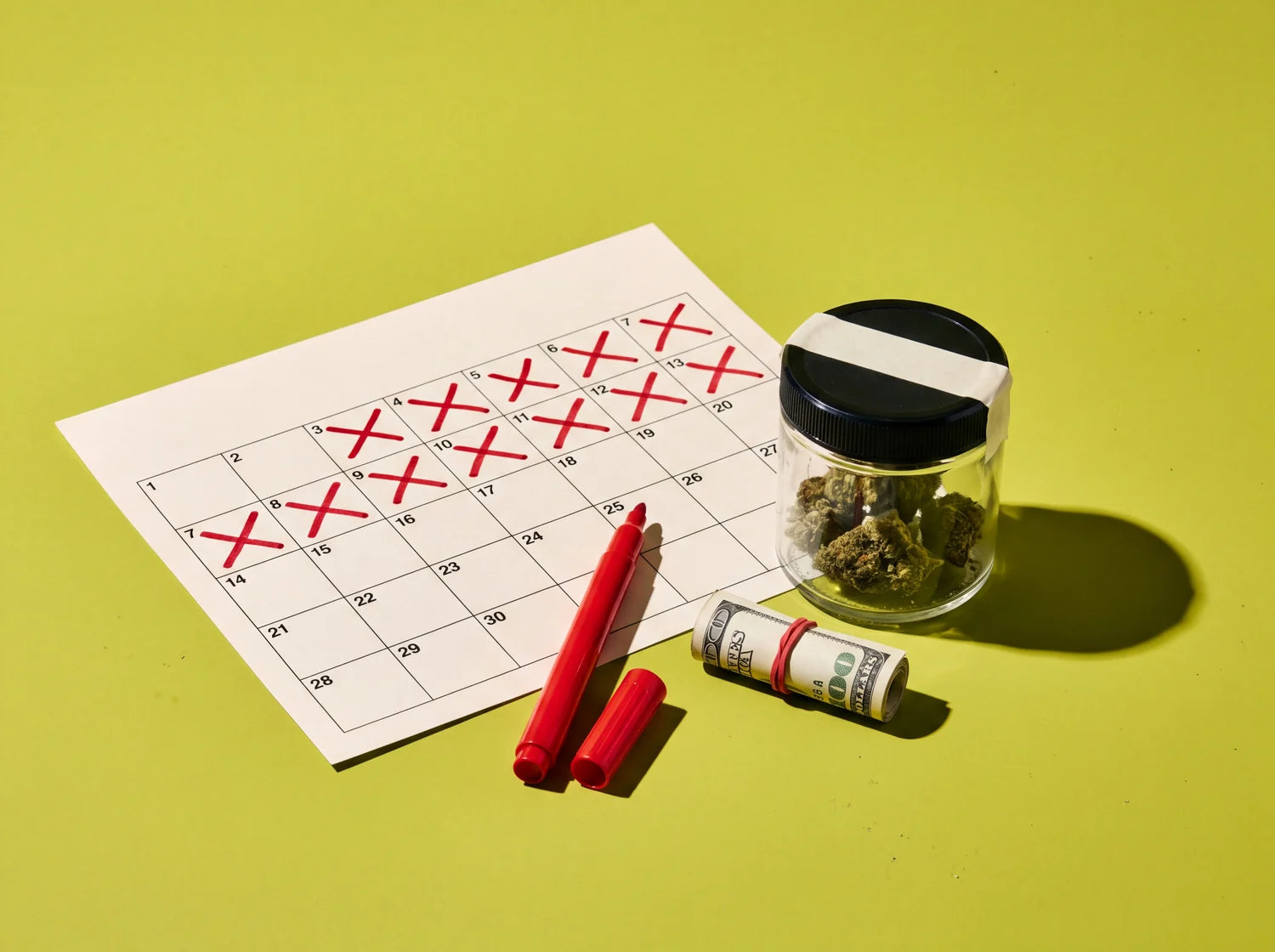 A calendar page with the first fourteen days crossed off in red marker, a sealed stash jar and a roll of dollar bills, on lime paper