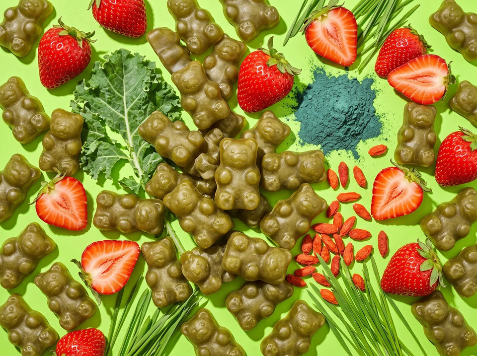 Green gummy bears scattered with fresh strawberries, kale and spirulina